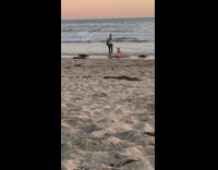Blonde girl split legs lay sand beach