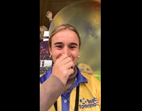 Woman laughs at kid press face against window