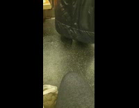 Woman wears giant black coat and pointy hat on the subway