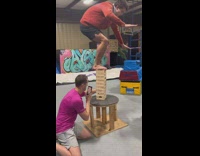 Guy balancing on jenga tower falls