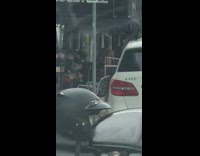 Shirtless guy red speedo waves lady car