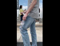 Woman in dress poses by the grills