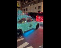Blue beetle car wrapped with Christmas lights