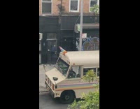 Girl sits pink chair brown school bus