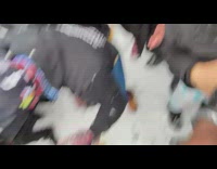 Guy pours alcohol onto snow and crowd cheers