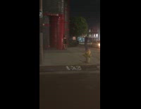 Woman black dress pictorial red tile wall nighttime