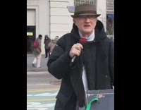 Black jacket grandpa sings into microphone street