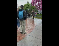 Guy fake laughs Disneyland long brown jacket 