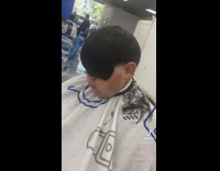 Barber gives client emo haircut with bangs 