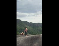 Woman lay on rock mountain buff guy