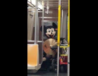 Collab WINY - Man in Mickey Mouse costume holding cymbal 