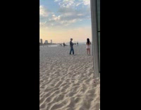 Collab IITW - Woman pink dress poses at the beach