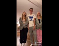 Guy points at two girls pink sweatpants 