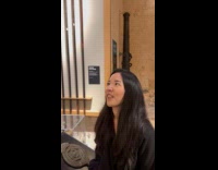 Woman imitate face of golden lion statue