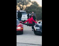 Lady does splits on two cars