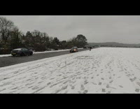 Man skis and jumps on the ramp while car pulled it
