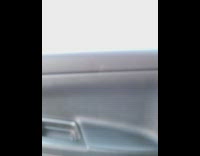 Guy driving on street while using a video game controller 
