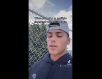 Man with dog on sidewalk next to poop