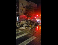 Garbage truck dumps waste on the road