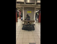 Man black jacket play wooden xylophone subway 