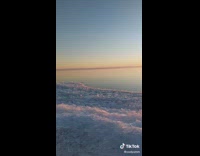 Guy skip rocks on canada frozen lake