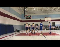 High schooler basketball player in blue jersey accidentally trips referee, referee faceplants into the wall