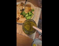 Girl uses tool to pick up pickles 