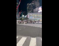 Man shirtless handstand middle of Shibuya crosswalk