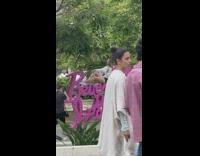 Woman sit on Beverly Hills is beautiful sign