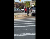 Policemen arrests man lifts him towards car