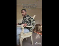 Guy rock his chair almost fall down