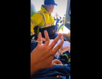 Guy with broken hand wants to thumbs up but shakas instead