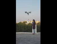 Woman receive rose from drone delivery rooftop