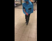 man blue square costume spinning in train staion