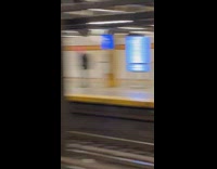 Guy waits for train in bunny head 