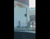 Girl hat pink top beside wall scooters