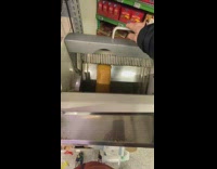 Man puts bread in bread slicer machine 