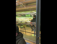 Woman takes picture of a a bird inside food court