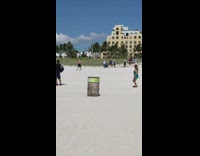 Woman green dress dance on beach trashcan 