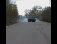 Truck driving down street does burnout drifts