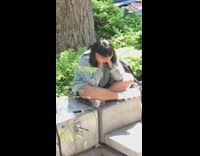 Girl sitting outside looks sad