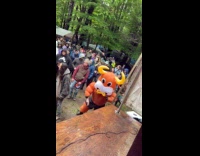 Artist plays saxophone at the stage campout