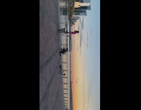Model in Pink Poses on a Platform with Sunset 