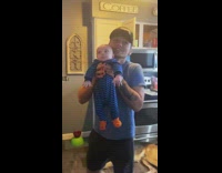 Guy scared to hold baby holds it incorrectly.