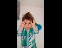 Baby with bottle and stares at camera