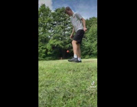 Guy kicks ball dog catches it in distance 