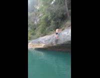 Guy backflips off giant rock and bellyflops on back into water