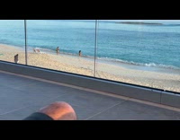 Couple on balcony reacts to couple on beach
