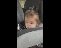 Baby in carseat rolls eyes 