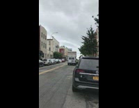 White van drives with stacked mattresses roof 